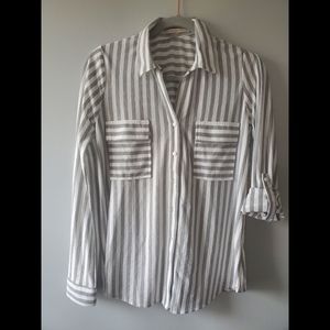 Black and white women's striped roll up sleeve, button down blouse shirt.
